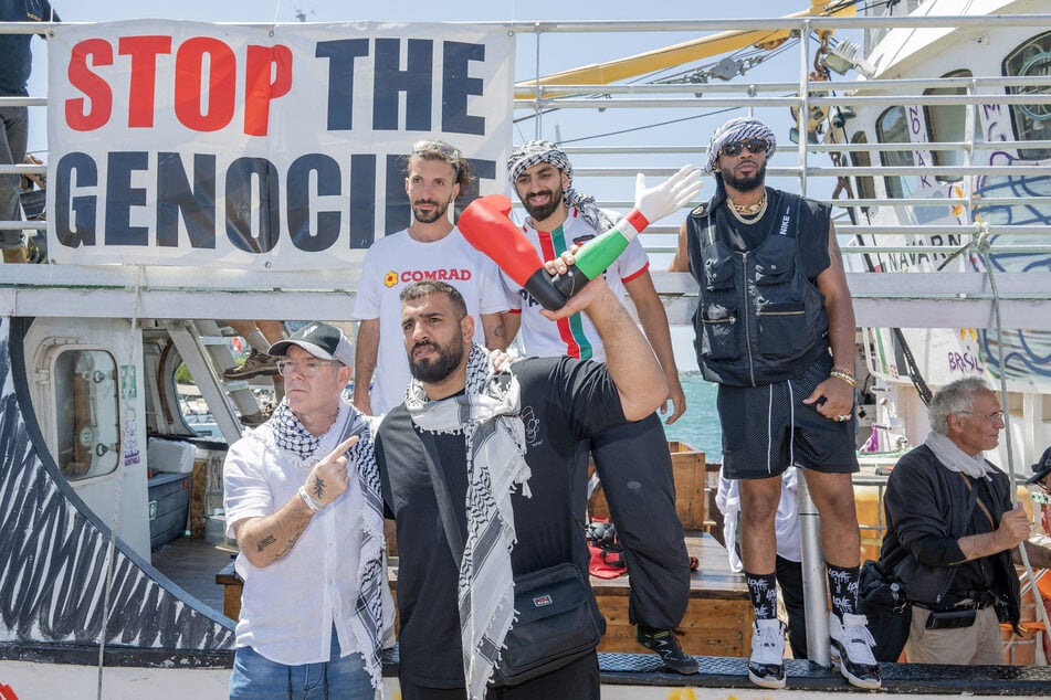 Crew members attend the Freedom Flotilla "Handala" boat's departure for Gaza at a port in Syracuse, Sicily, southern Italy, on July 13, 2025.