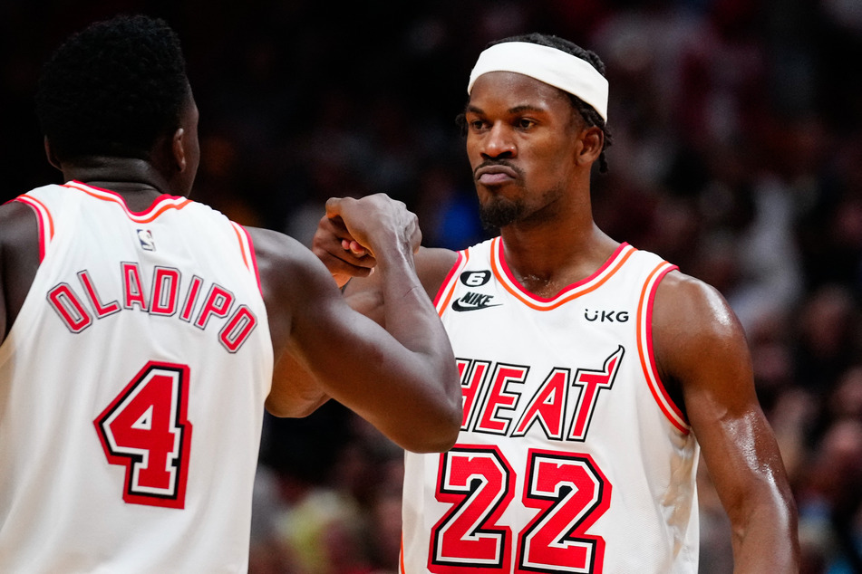 Miami Heat forward Jimmy Butler celebrates with guard Victor Oladipo after scoring against the Oklahoma City Thunder during the fourth quarter at FTX Arena.