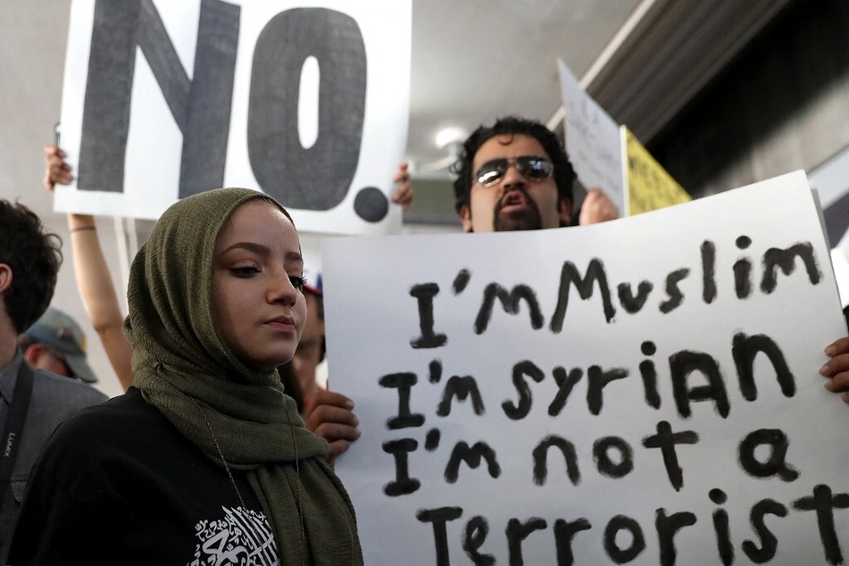 Protesters hold signs during a demonstration against Donald Trump's Muslim Ban at the Los Angeles International Airport.