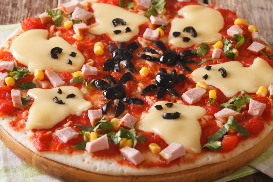 Pizza mit Käse-Geistern und Oliven-Spinnen sieht nicht nur gruselig aus, sondern schmeckt unheimlich gut.