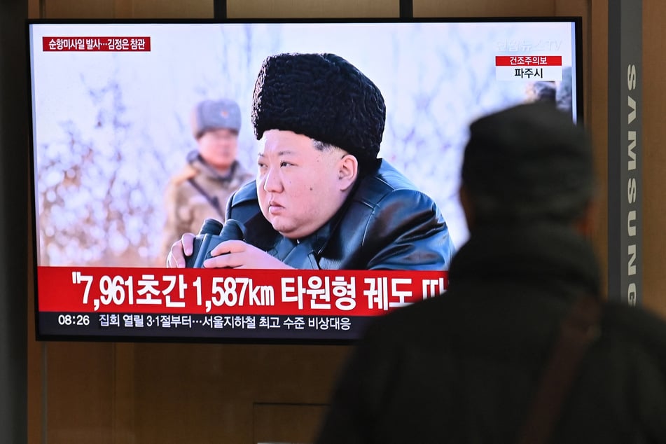 A man watches a television screen showing news footage of North Korea's leader Kim Jong Un observing a test-launch of strategic cruise missiles, at a train station in Seoul on Friday.