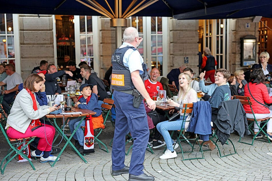 Ein Bundespolizist verteilte EM-Anstecker an österreichische Fans.