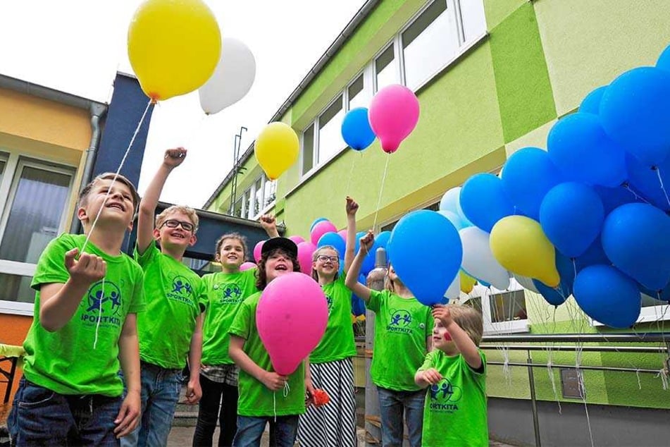 Die Kinder der Sportkita Eschenweg bereiten Luftballons zum Aufsteigen vor, 
an denen sie ihre Wünsche für die Zukunft angeheftet haben.