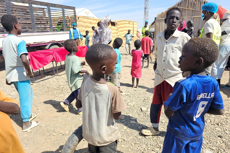 Displaced Sudanese children gather near a food distribution point at the Abu al-Naga displacement camp in Gedaref State on February 6, 2026.