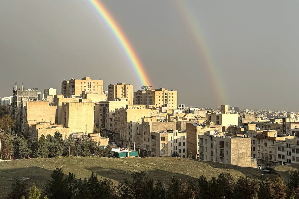 A double rainbow arcs over a building after rainfall as Iranians celebrate the spring holiday of Nowruz in Tehran on March 20, 2026.