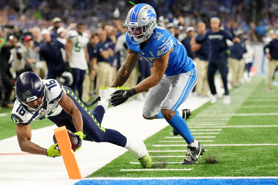 Tyler Lockett (l) of the Seattle Seahawks scored an overtime touchdown, winning the game over the Detroit Lions at Ford Field.