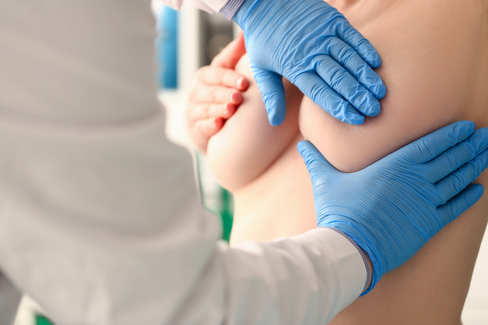 A doctor examines a woman's breasts (stock image).