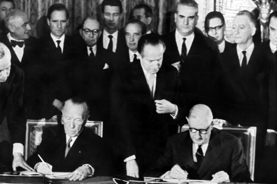 Der französische Staatspräsident Charles de Gaulle (r) und der deutsche Bundeskanzler Konrad Adenauer unterzeichnen am 22.1.1963 im Pariser Elysee-Palast den deutsch-französischen Freundschaftsvertrag.