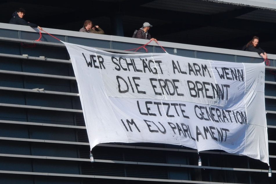 Mitglieder der Letzten Generation haben ein Banner an der East Side Mall ausgerollt.