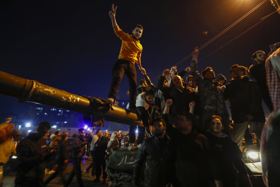 The arrival of opposition fighters is celebrated in the Syrian capital Damascus.