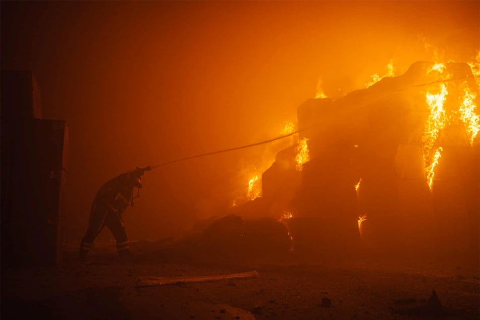 A firefighter at a site of a tobacco factory in Kyiv, Ukraine, damaged during a Russian drone strike.