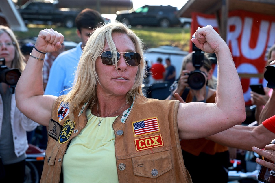 Rep. Marjorie Taylor Greene flexes her muscles during a Bikers for Trump campaign event held in Plainville, Georgia on May 20, 2022.