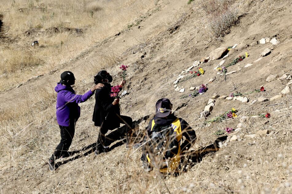 Fans place flowers at the site of the helicopter crash that killed Kobe Bryant and his daughter Gianna.
