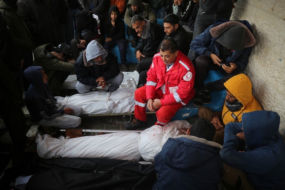 Palestinian Red Crescent medics mourn during a funeral in Deir el-Balah in the central Gaza Strip, on January 11, 2024, after an Israeli strike on an ambulance killed six people.