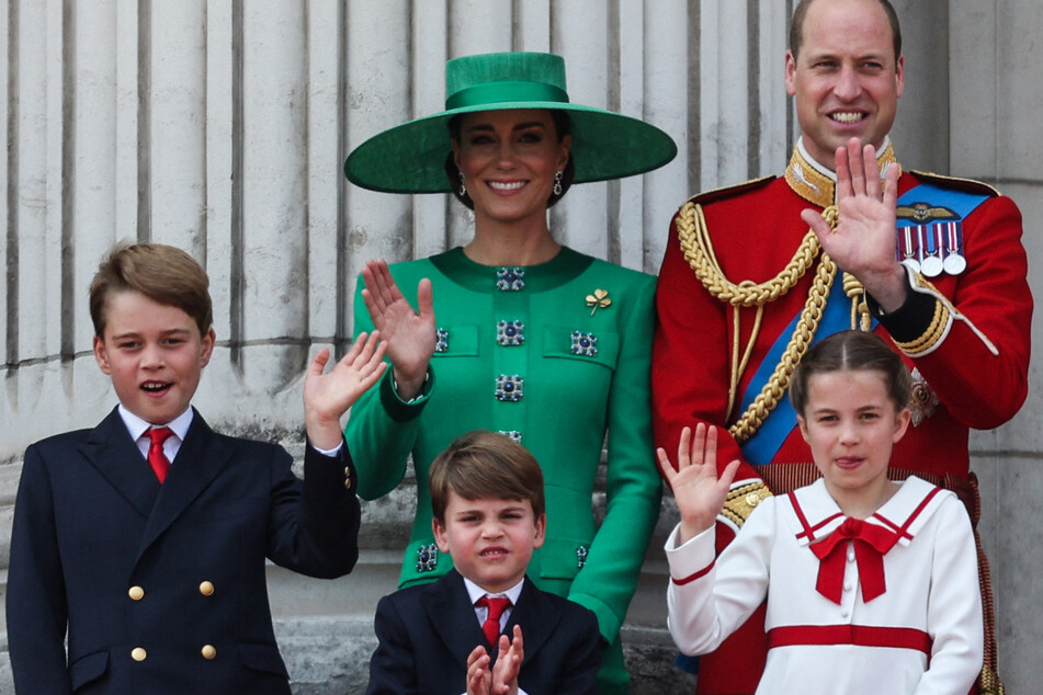 (L-R) Britain's Prince George of Wales, Britain's Catherine, Princess of Wales, Britain's Prince Louis of Wales, Britain's Prince William, Prince of Wales, and Britain's Princess Charlotte of Wales wave from the balcony of Buckingham Palace after attending the King's Birthday Parade in London on June 17, 2023.