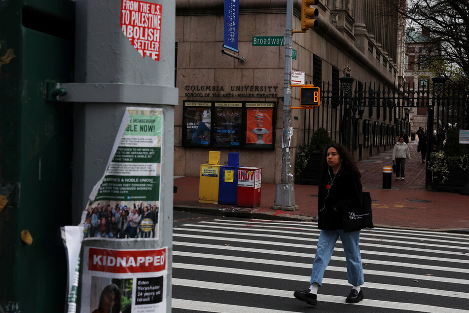 Torn signs about the ongoing conflict in Israel and Gaza hang across from the Lerner Pedestrian Gate of Columbia University in New York.