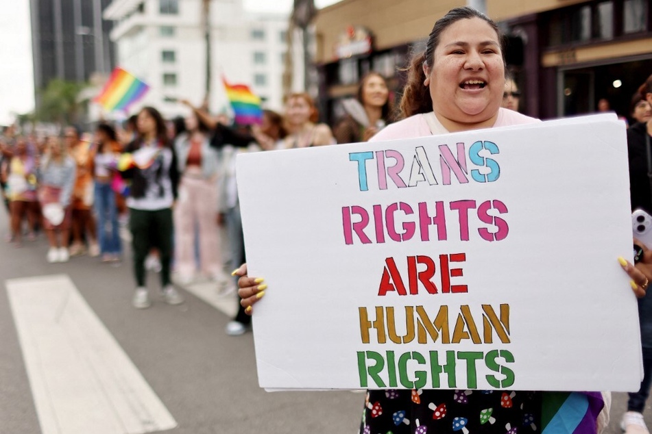 A participant holds a "Trans Rights Are Human Rights" sign during the 2023 Los Angeles Pride Parade on June 11, 2023.