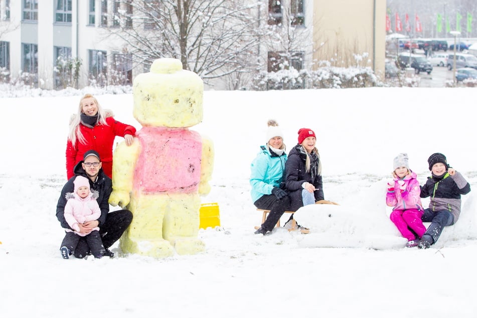 Benjamin Völker und Sandy Rosenberg (ganz links) haben eine Lego-Figur aus Schnee für ihre Kinder Amberly und John (ganz rechts) kreiert.