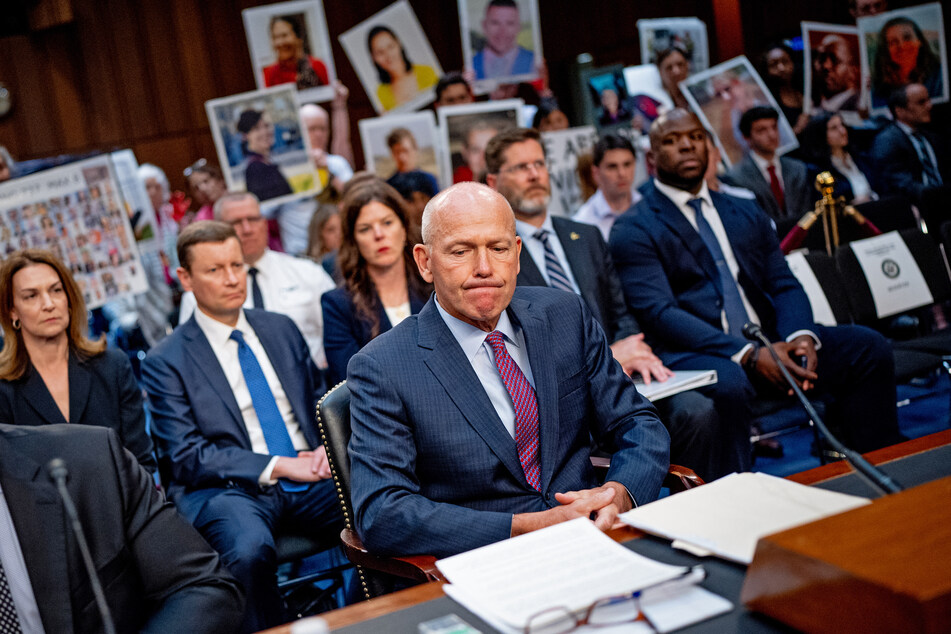 Family members of those killed in the Ethiopian Airlines Flight 302 and Lion Air Flight 610 crashes hold photographs of their loved ones as Boeing CEO Dave Calhoun arrives for a Senate Homeland Security and Governmental Affairs Investigations Subcommittee hearing on Boeing's broken safety culture on Capitol Hill on June 18, 2024 in Washington, DC.