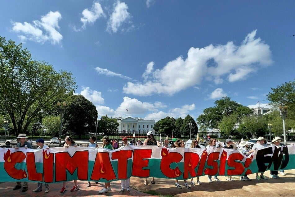 Environmental activists call for an end to fossil fuels in a climate action rally outside the White House.