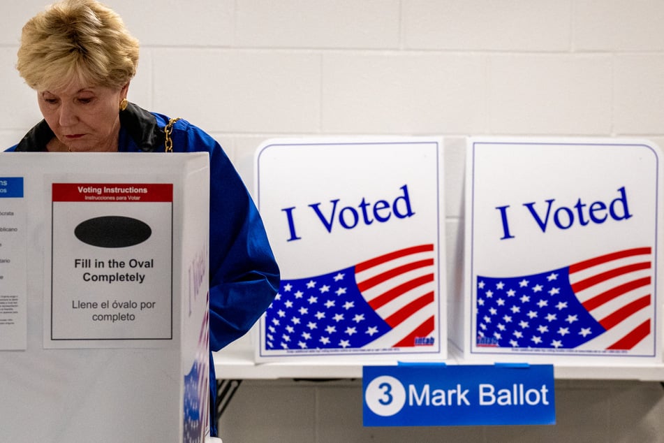 The first early voters cast their ballots Friday for November's knife-edge presidential election.