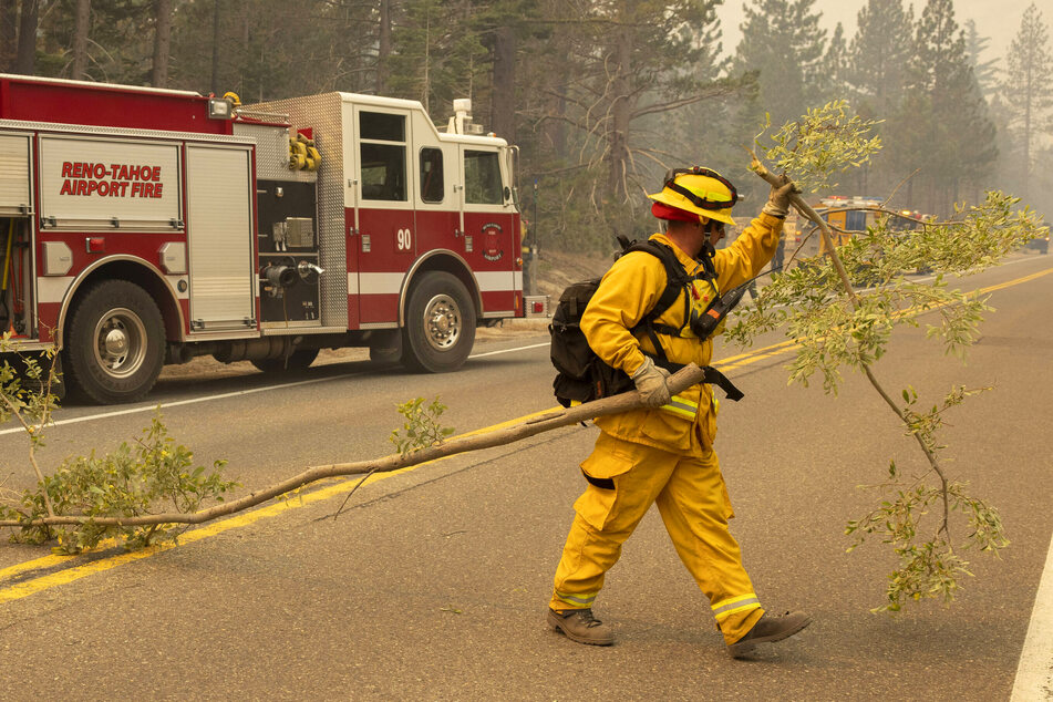 Nevada firefighter clearing a road during efforts to contain Caldor wildfire in August 2021.
