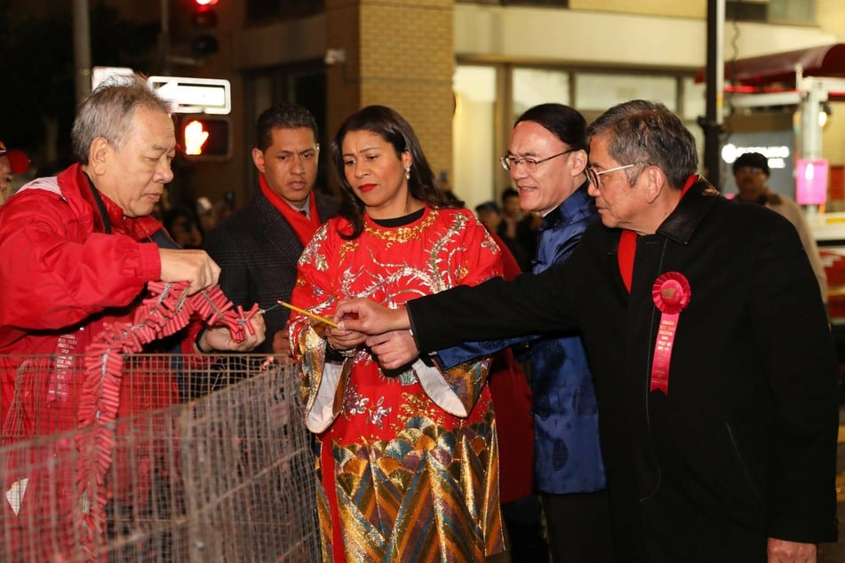 San Francisco Mayor London Breed (c.) lights firecrackers during a parade celebrating Chinese Spring Festival in San Francisco (archive image).