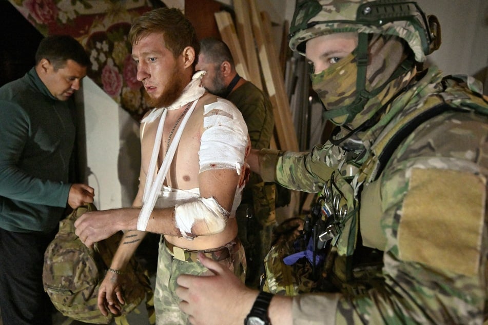 Medics help a local resident in a field hospital at an undisclosed location in the Kursk region on Sunday.