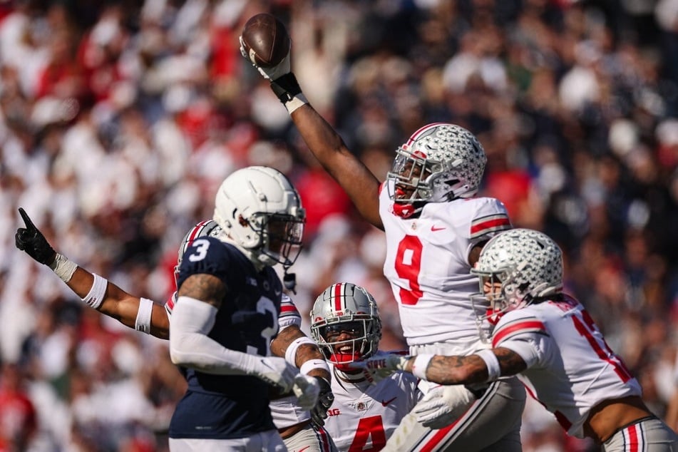 Zach Harrison #9 of Ohio State (c) celebrates after an interception catch from Penn State during their conference meeting during Week 9 of the college football season.