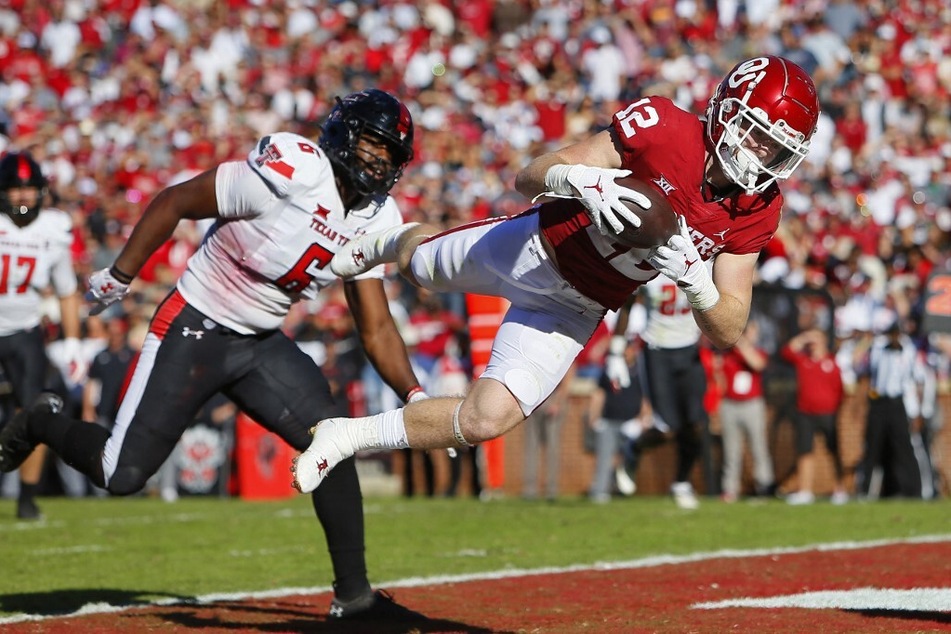 Wide receiver Drake Stoops of the Oklahoma Sooners pulls down a 12-yard touchdown catch against the Texas Tech Red Raiders.