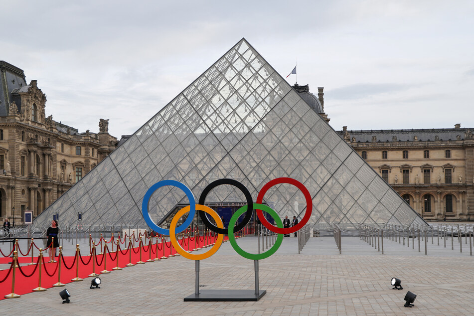 The Olympic Rings stand outside Paris' Pyramide du Louvre during a gala dinner hosted by the International Olympic Committee and the French Presidency.