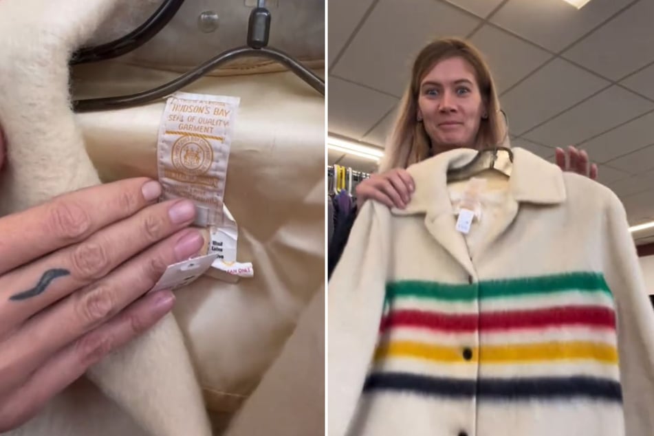 Una mujer no puede creer su suerte cuando mira de cerca una chaqueta en una tienda de segunda mano