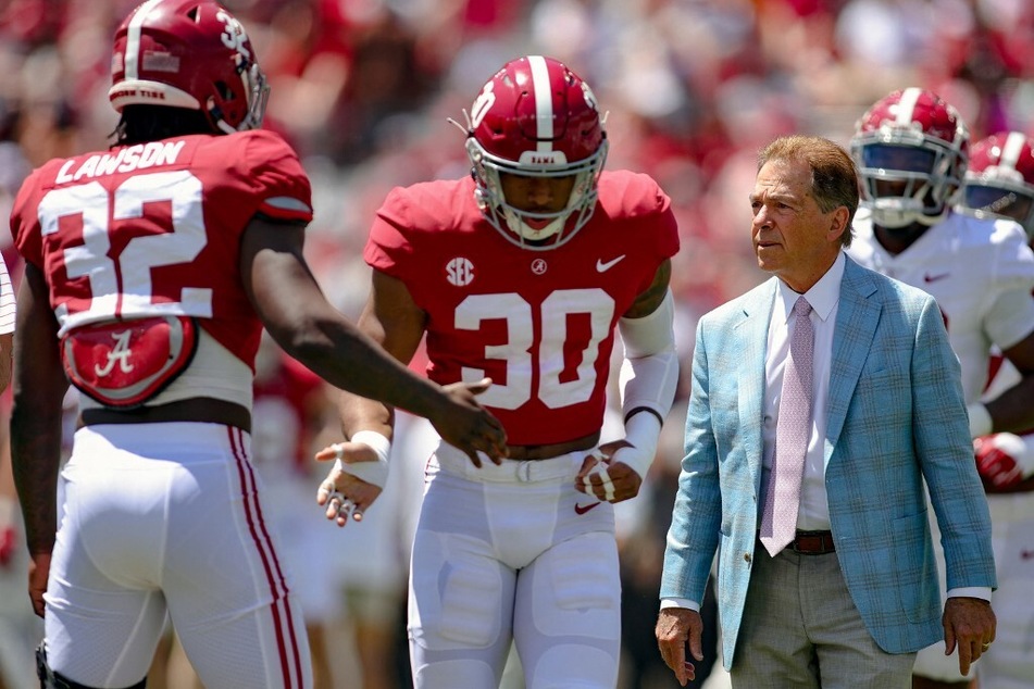 After the release of the 2024-2025 SEC college football schedule, fans are in a frenzy over Alabama and Coach Nick Saban (r.) finally facing Power 5 opponents on the road.