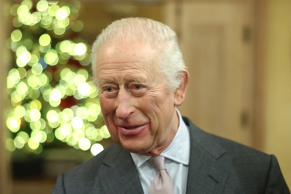 King Charles III on Friday joked that he was "still alive" as he met east London community members at the end of a year in which the British monarch has battled cancer.