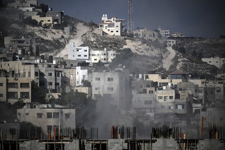 Smoke rises among buildings during an Israeli army raid in Jenin in the occupied West Bank on August 30, 2024.