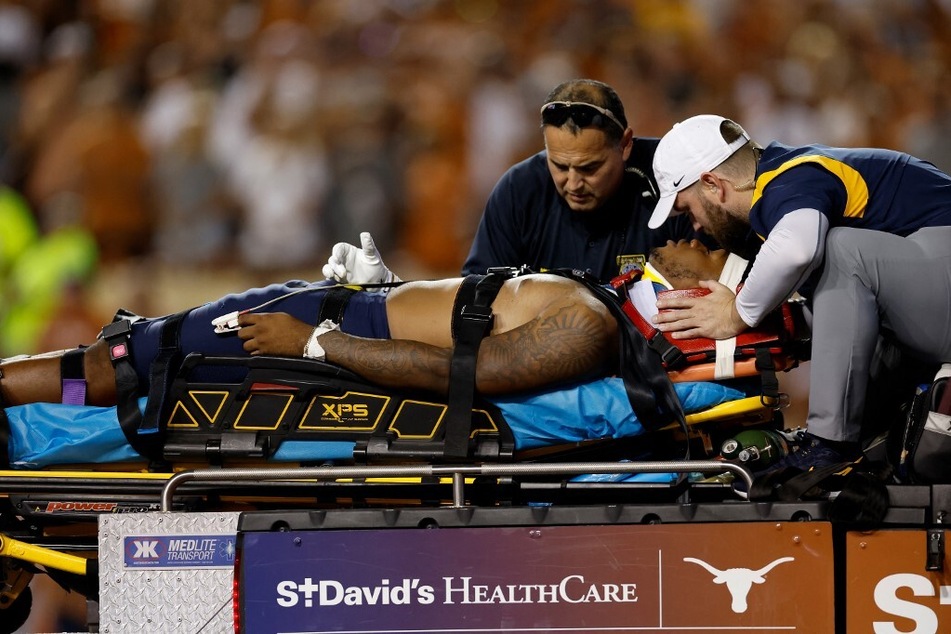 CJ Donaldson of the West Virginia Mountaineers gives a thumbs up as he is carted off the field in the second half against the Texas Longhorns at Darrell K Royal-Texas Memorial Stadium on Saturday night.
