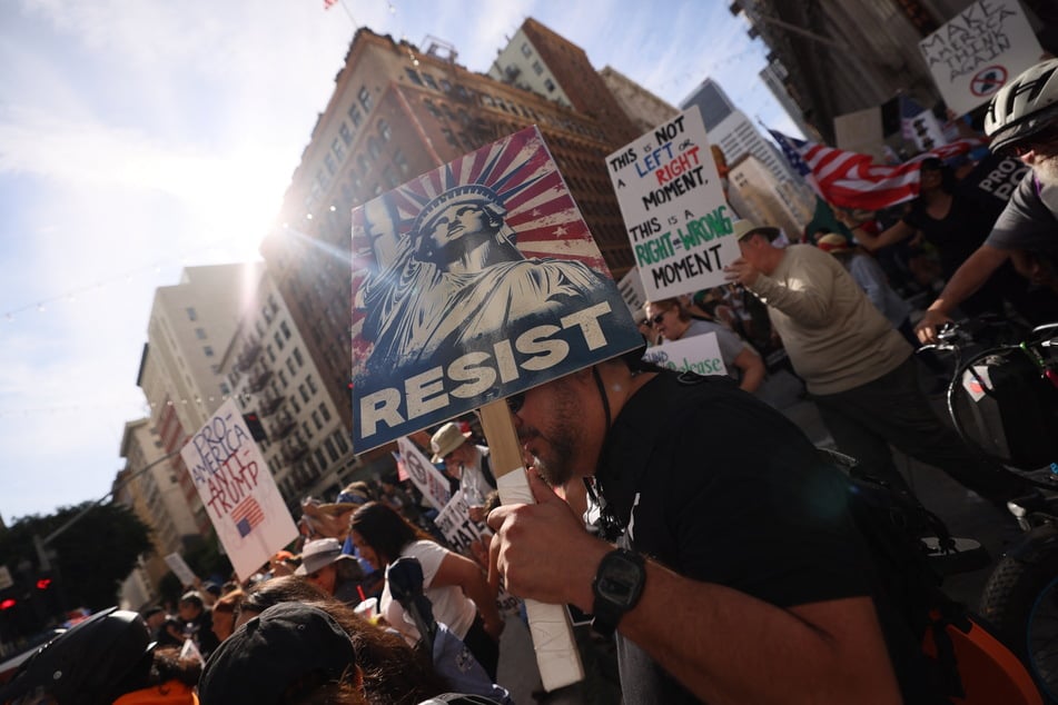 ETIENNE LAURENT / AFP Photo by ETIENNE LAURENT / AFP Protestors holding signs march from City Hall during the "No Kings" national day of protest in Los Angeles on March 28, 2026.