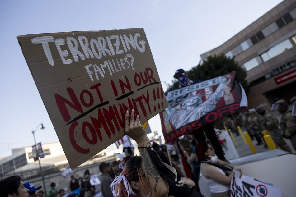 Demonstrators face a mix of US Marines, National Guard members, and Department of Homeland Security police officers as they protest in front of the Metropolitan Detention Center following federal immigration raids, in Los Angeles, California, on July 4, 2025.