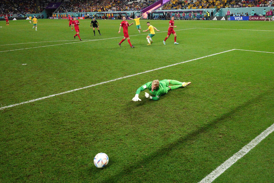 Danish goalkeeper Kasper Schmeichel watches as Mathew Leckie's shot rolls into the goal.