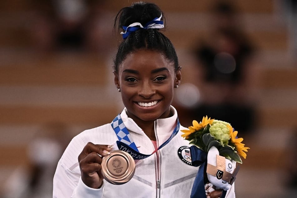 Simone Biles showed off her Olympic bronze medal in Tokyo.