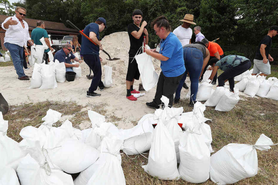 Bewohnern füllen Sandsäcke im Blanchard Park. Wegen des herannahenden Hurrikans "Dorian" hat der Gouverneur des US-Bundesstaates Florida den Notstand ausgerufen.