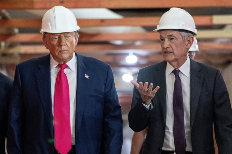 President Donald Trump (l.) speaks with Federal Reserve Chair Jerome Powell as he visits the Federal Reserve in Washington DC on July 24, 2025.