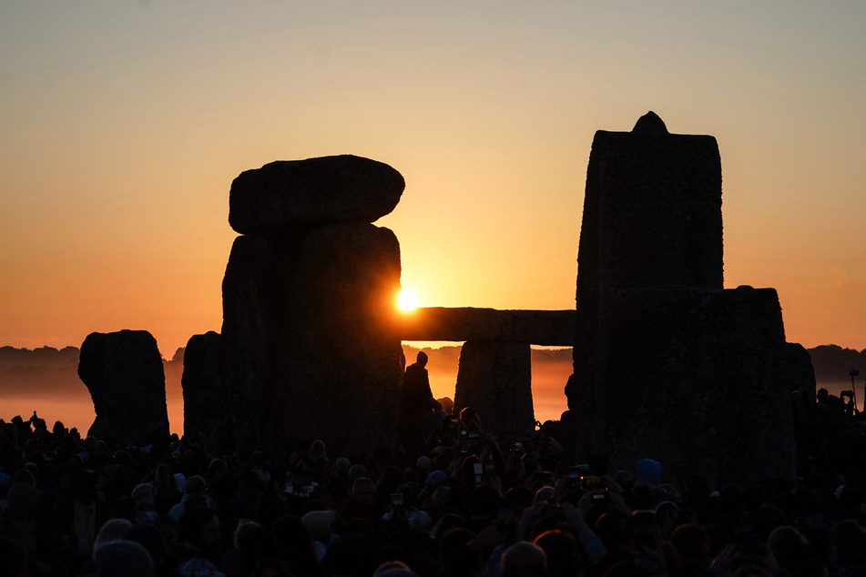 The sun rises at Stonehenge, near Amesbury, in Wiltshire, southern England on June 21, 2024, during the Summer Solstice festival, which dates back thousands of years.