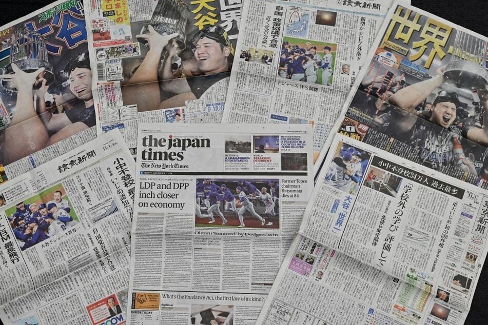 A selection of Japanese newspapers' front pages show images of Shohei Ohtani and the Los Angeles Dodgers celebrating their 2024 World Series win.