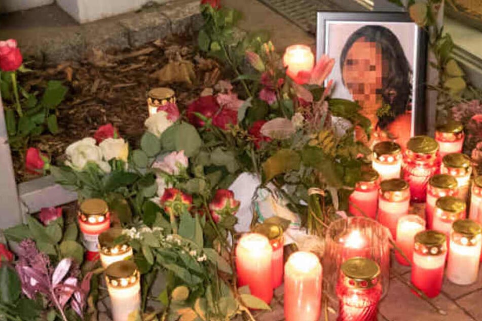 Trauernde haben Blumen und Kerzen vor das Wohnhaus der Getöteten gelegt.