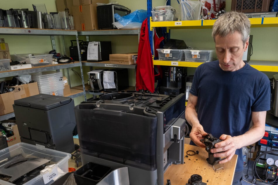 Lothar Prohl, Servicetechniker, repariert in der Werkstatt der HSC HomeElectronic Service Center GmbH in Leipzig einen Kaffeeautomat.