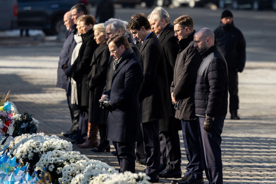 Ukraine's President Volodymyr Zelenskiy with his wife Olena, along with European and Canadian leaders, visit a makeshift memorial place displaying Ukrainian flags with the names of fallen service members at the Independence Square in Kyiv.