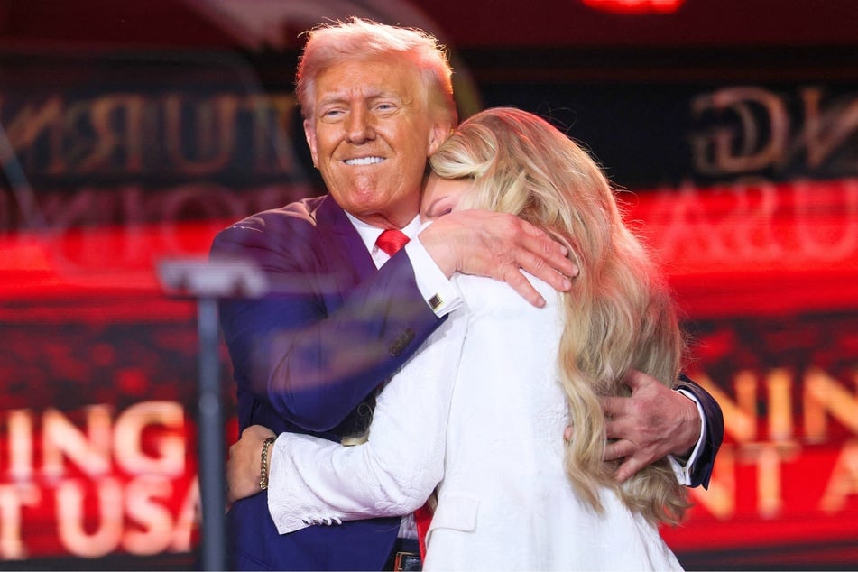 President Donald Trump (l.) hugging Erin Kirk during a memorial service for her husband and political activist Charlie Kirk in Glendale, Arizona on September 21, 2025.