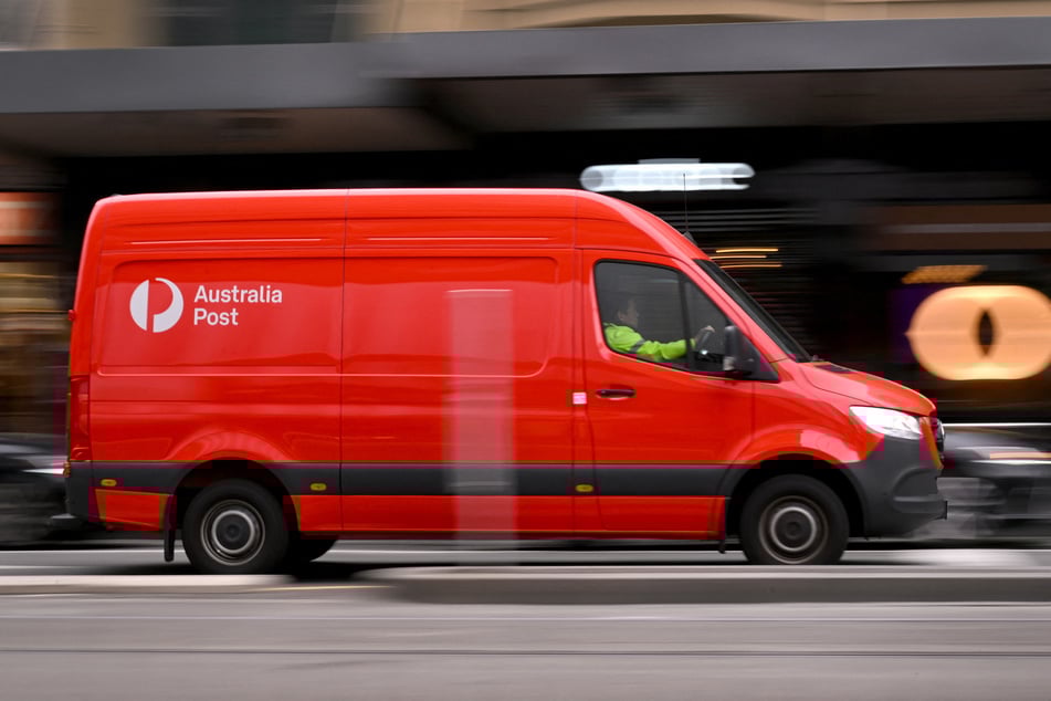 An Australia Post van drives through the central business district in Melbourne on August 26, 2025.