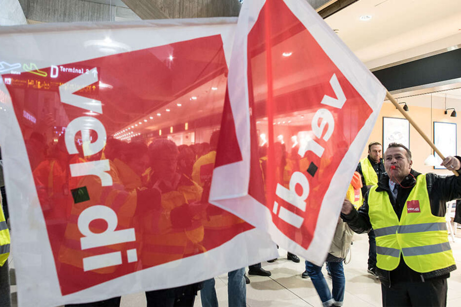 Hier wurde schon gestreikt: Mitglieder der Gewerkschaft Verdi stehen am 10.01.2019 mit Fahnen am Flughafen Köln/Bonn in einem Terminal. An den Airports Köln/Bonn, Düsseldorf und Stuttgart streikte das Sicherheitspersonal jeweils ganztägig.